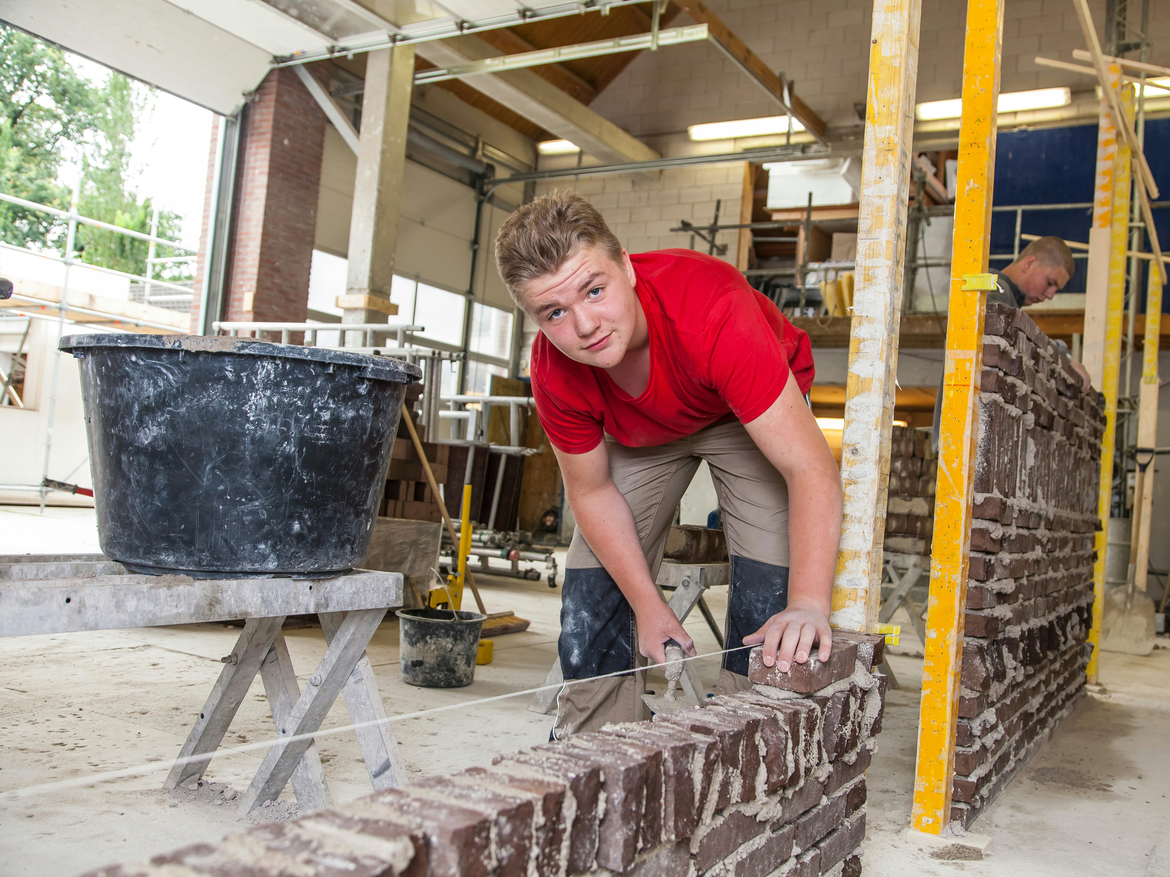 Jongen metselt muurtje
