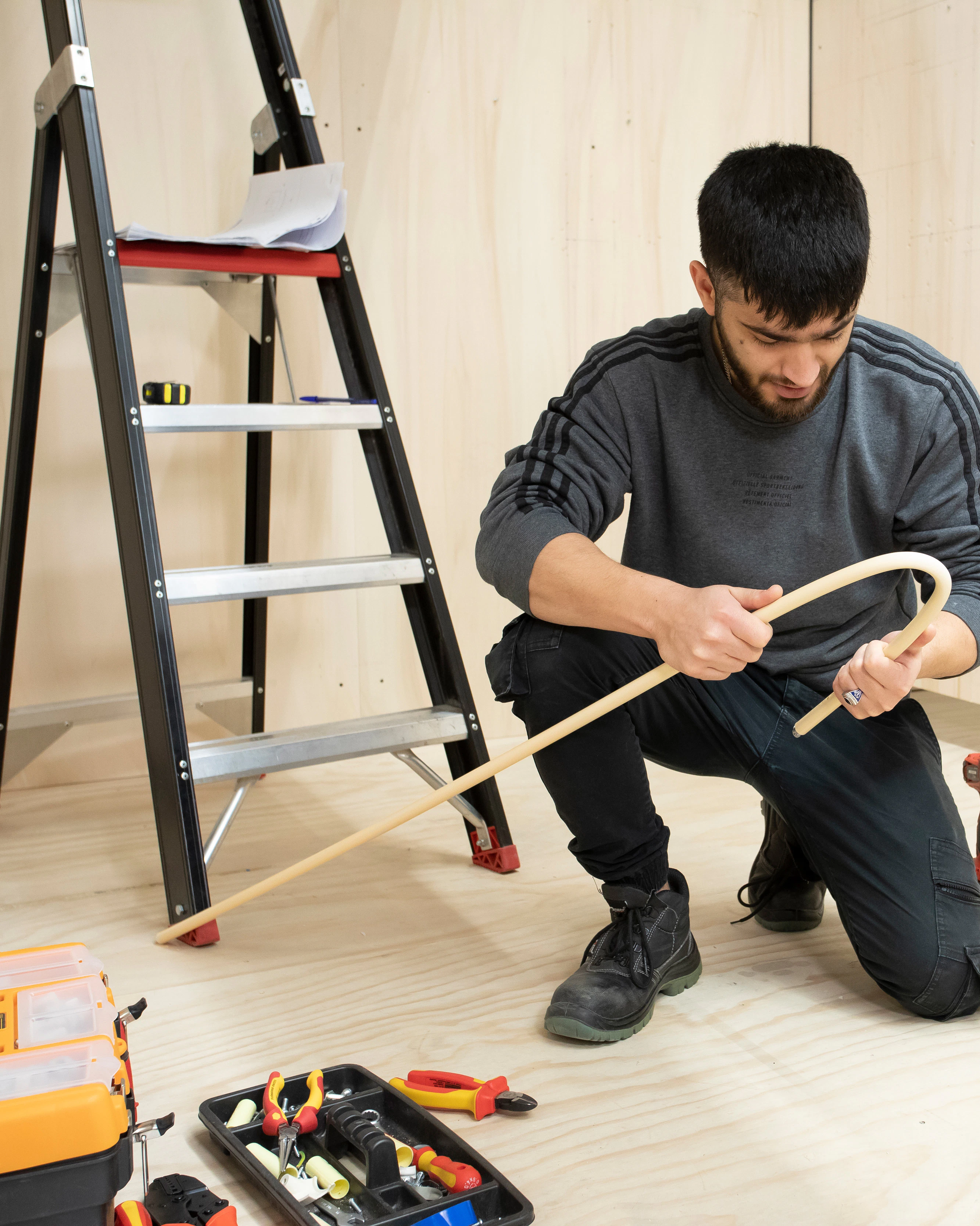 Jongen bezig met het leggen van een leiding