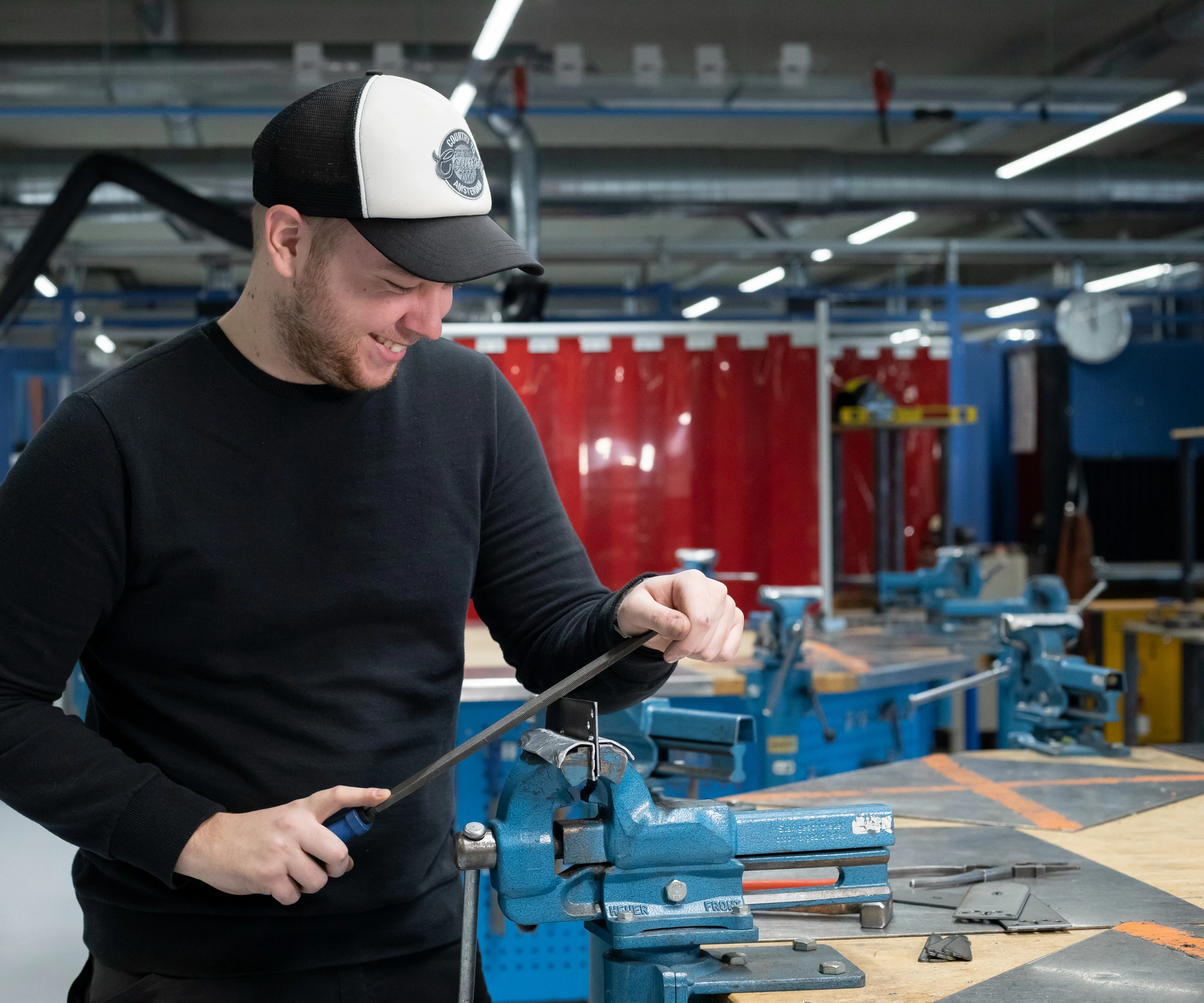 Jongen in het technieklokaal veilt een buisje op maat.