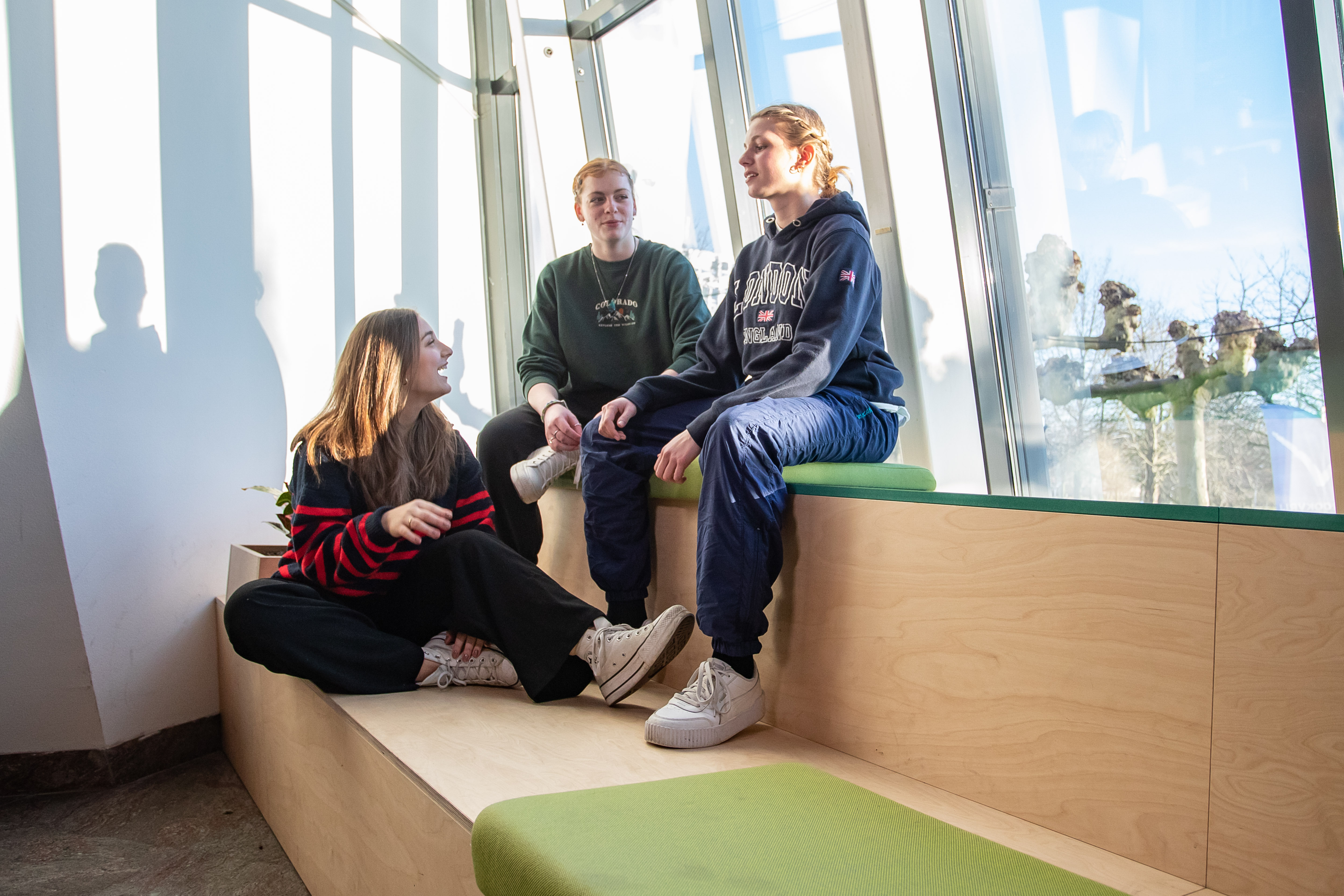 3 studenten zitten op een bankje