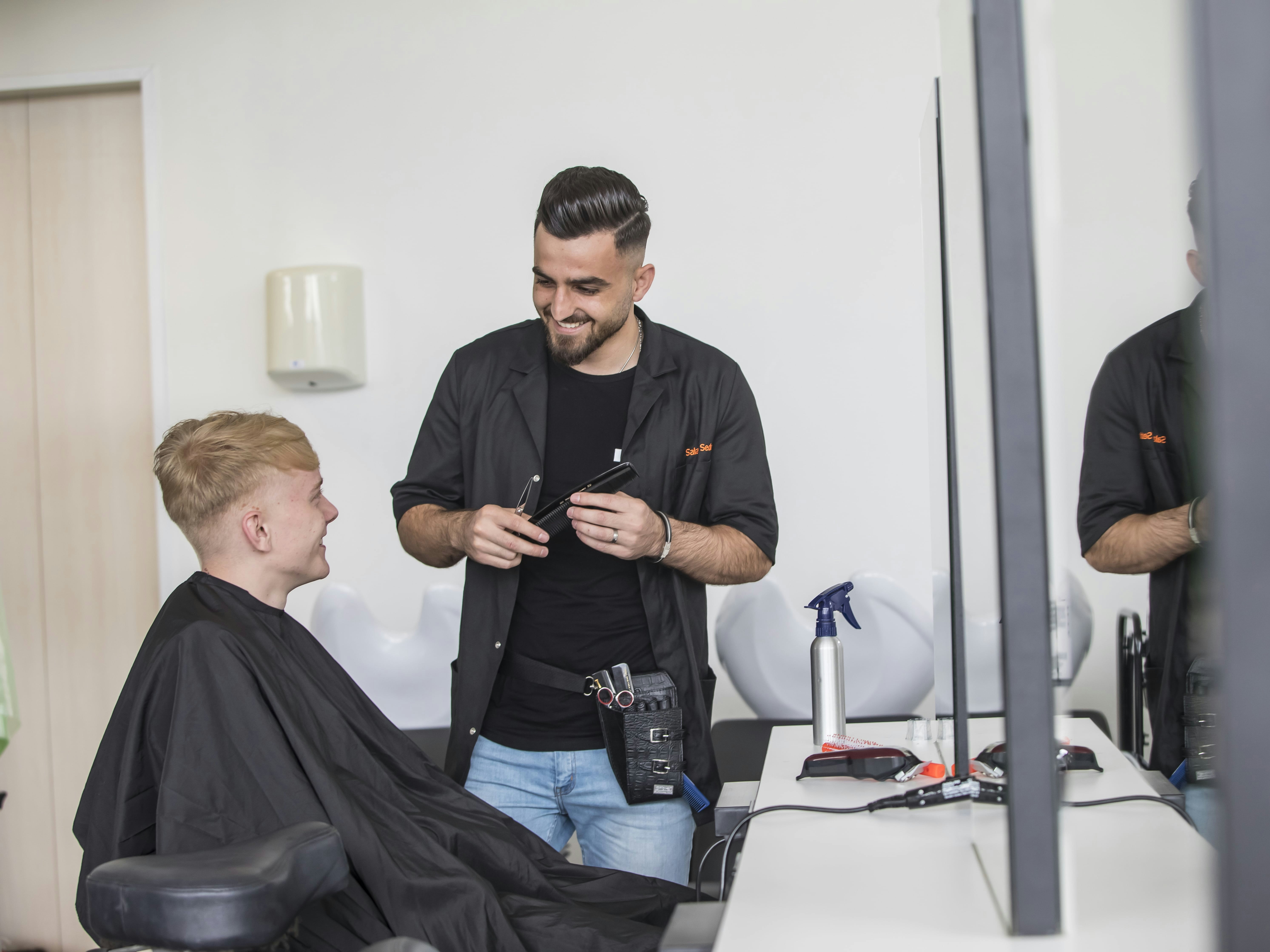 Mannelijke student adviseert een mannelijke klant.