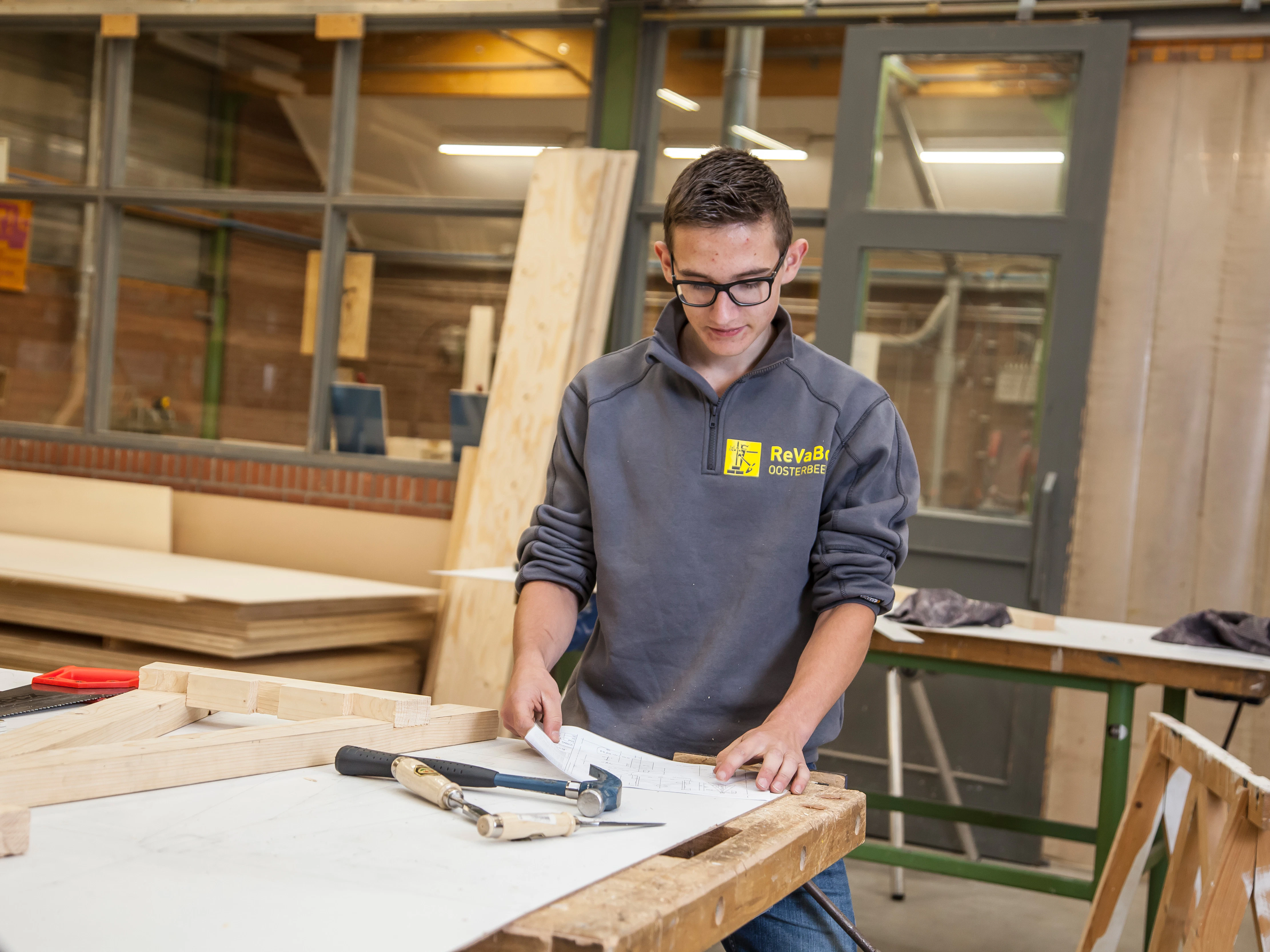 Student aan werktafel met werkteningen